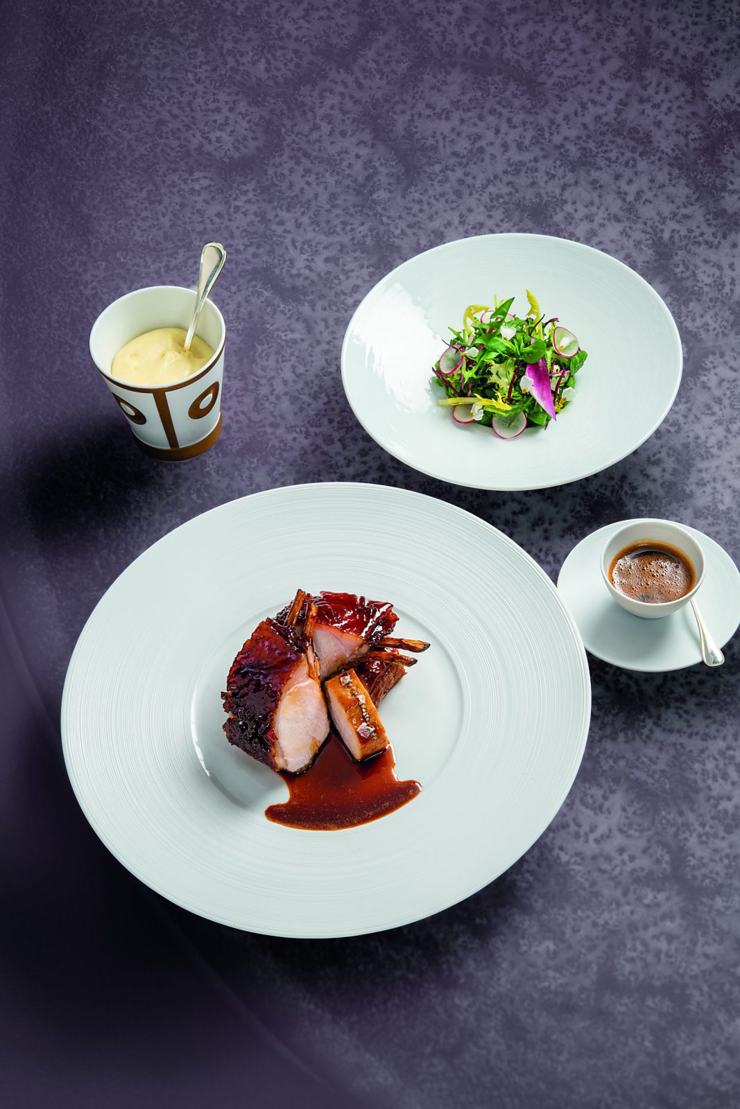 Carré de porcelet au foin, jus réduit et salade pastorale aux herbes